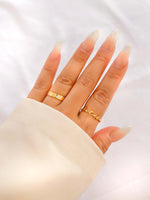 gold ring with enamel lettering showing on models hand